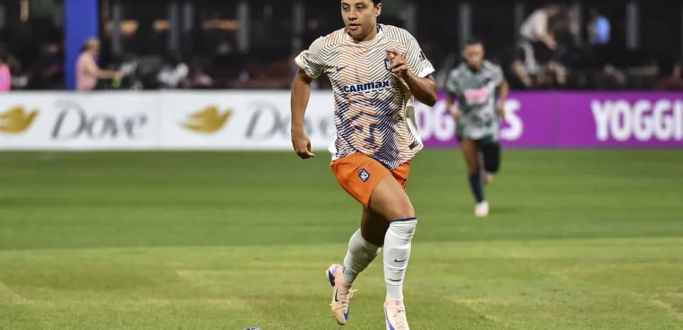 Joueuse courant avec le ballon sur le terrain