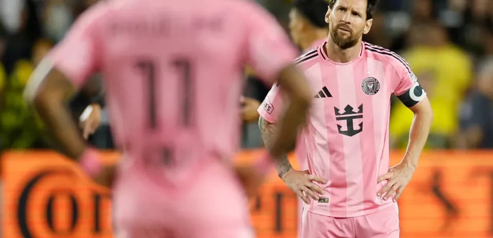 Lionel Messi and teammate during match in pink jerseys