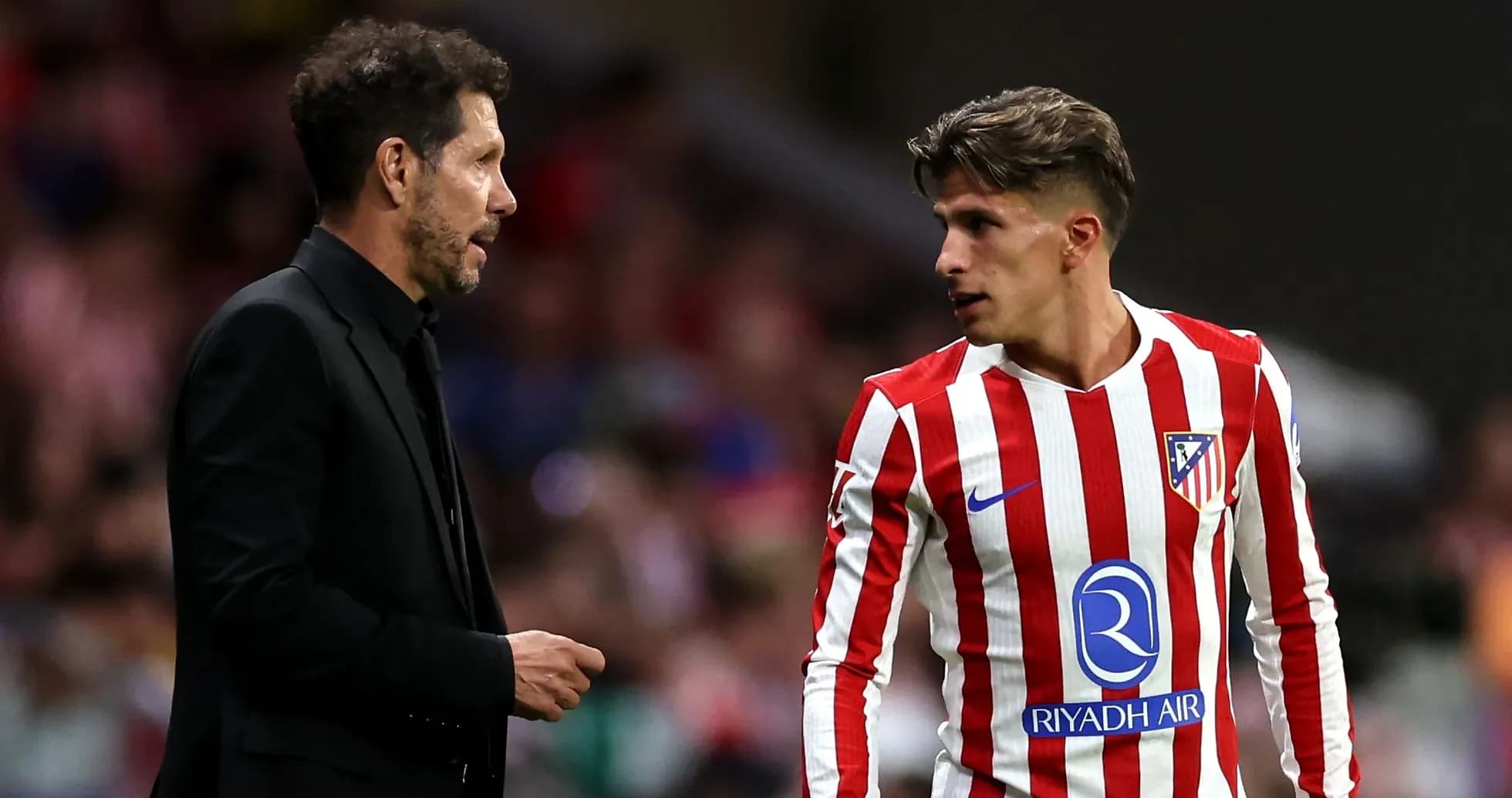 Entraîneur discutant avec joueur d'Atlético de Madrid