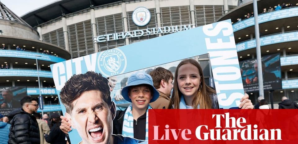 Supporters holding Manchester City sign at Etihad Stadium