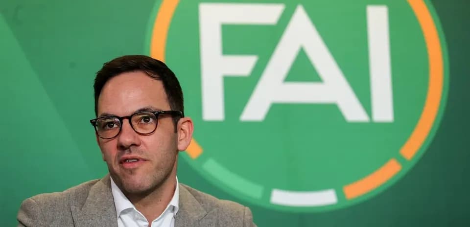 Person speaking at FAI press conference backdrop