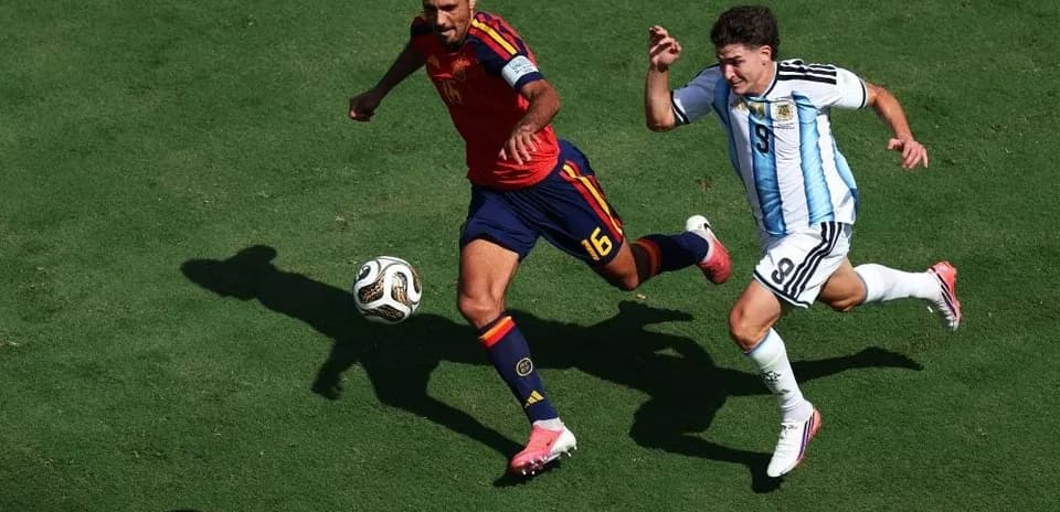 Joueurs espagnol et argentin en course pour le ballon