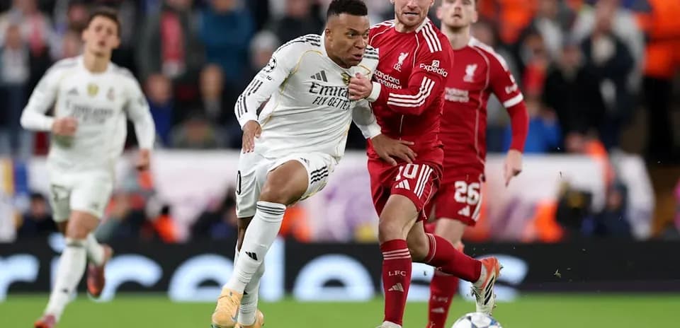 Kylian Mbappé dribbling past Liverpool defenders