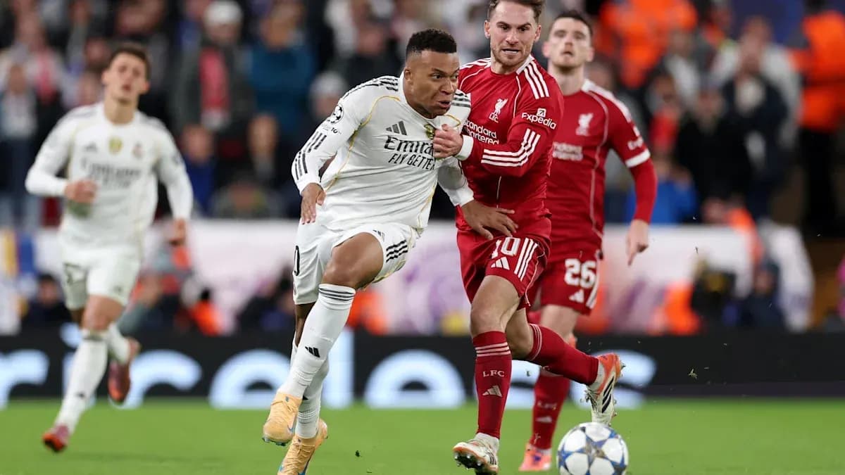 Kylian Mbappé dribbling past Liverpool defenders