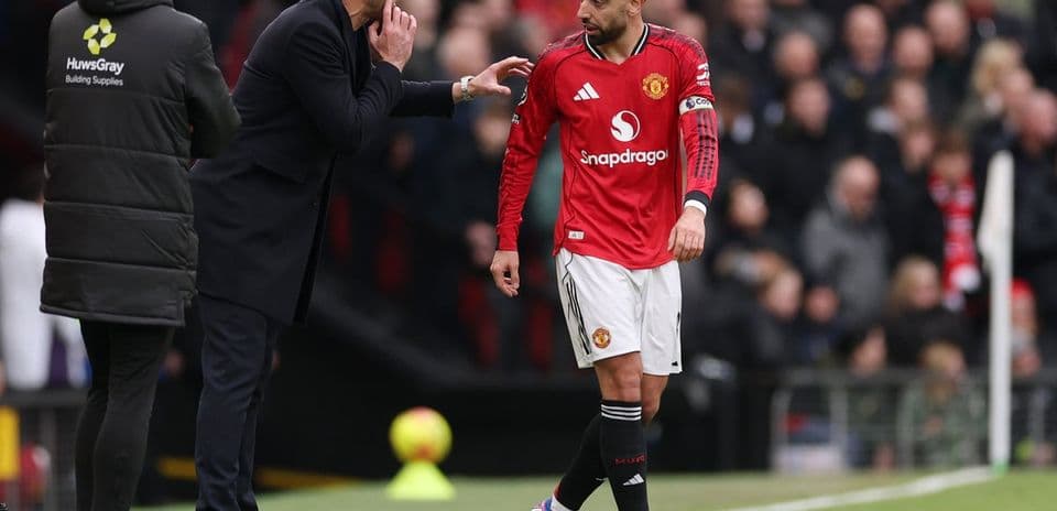 Entraîneur donnant des instructions à un joueur de Manchester United