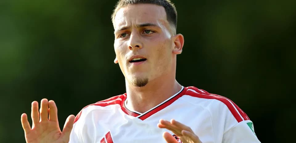 Joueur de football en maillot blanc gesticulant