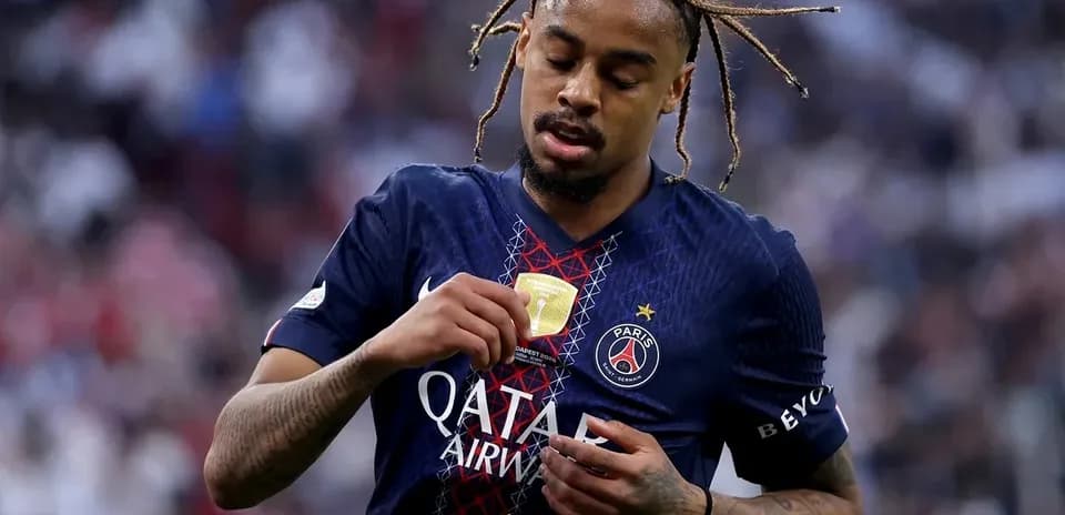 Joueur du PSG inspectant son médaillon de victoire