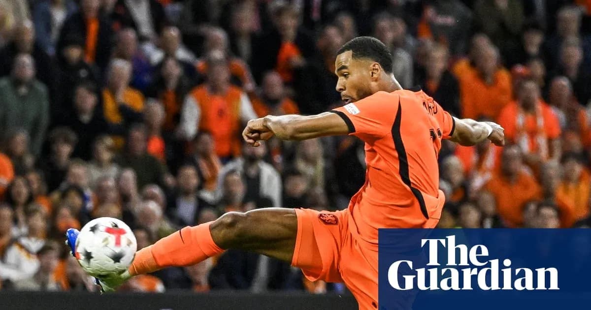 Joueur en maillot orange tirant le ballon lors du match