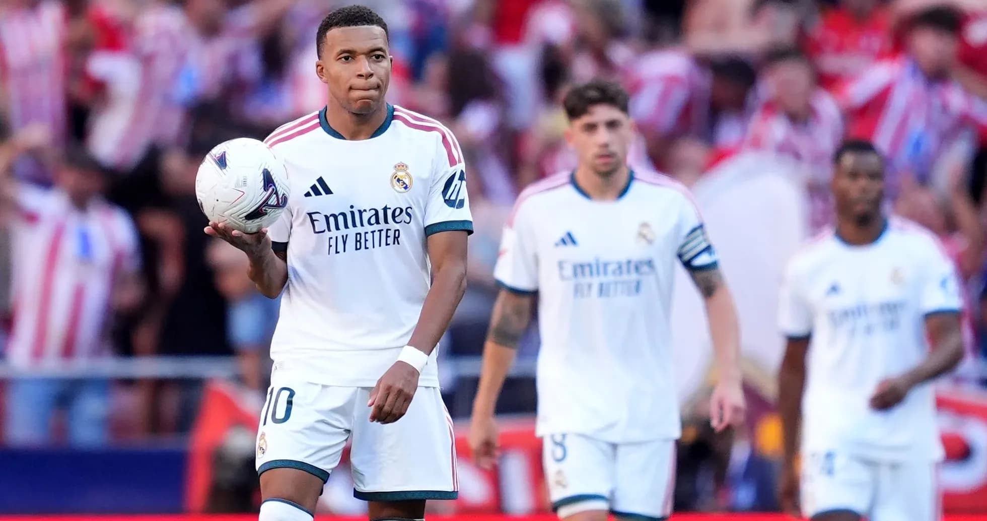 Kylian Mbappé tenant un ballon avec coéquipiers