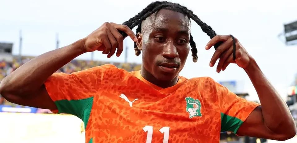 Joueur de football en maillot orange célébrant un moment