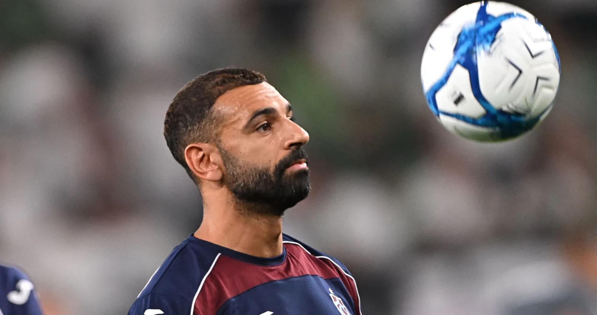 Joueur de football contrôlant un ballon en l'air