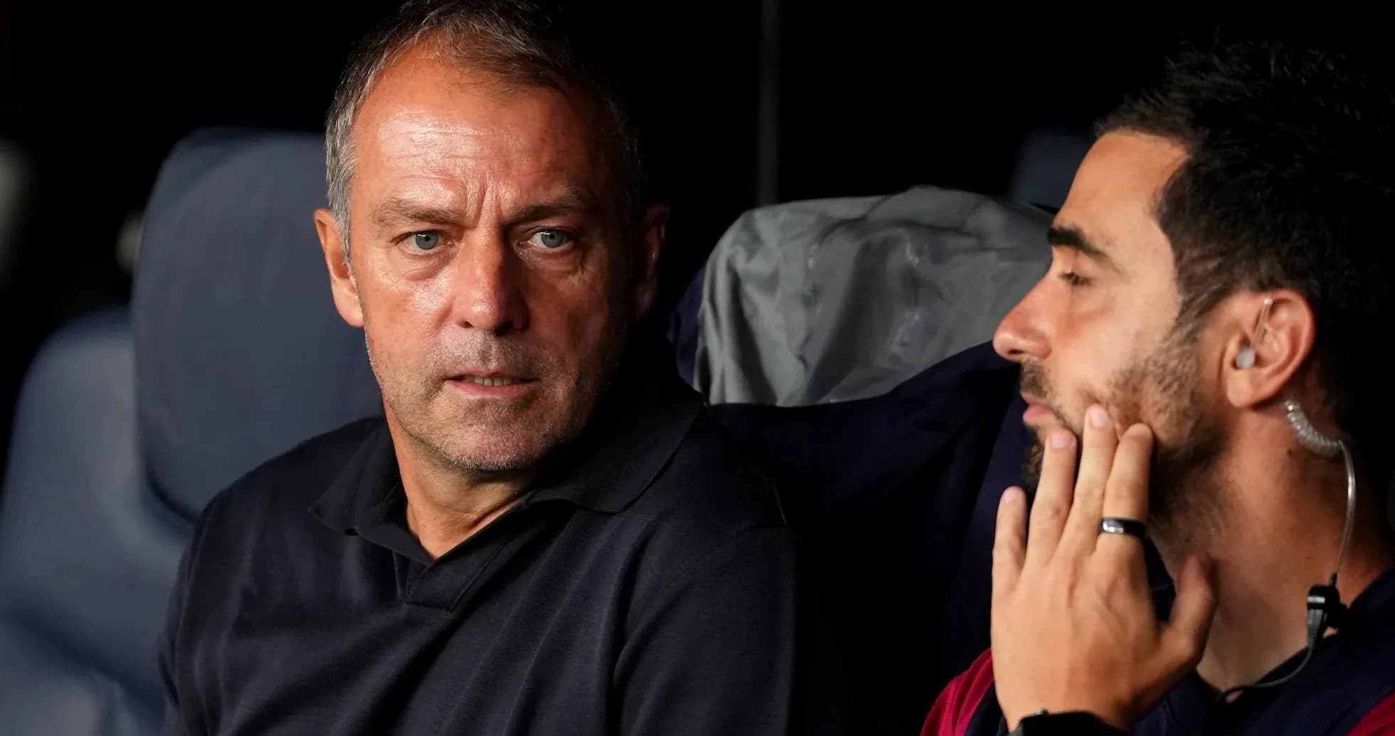Deux entraîneurs discutant sur le banc de touche