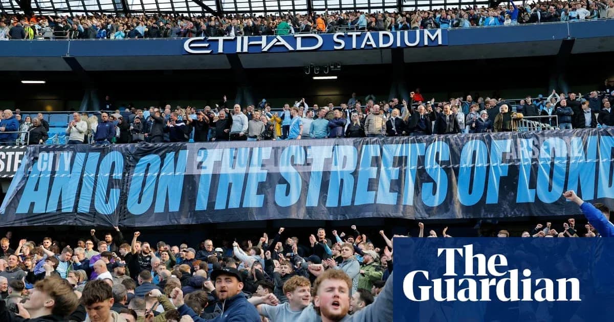 Supporters cheering with banner at Etihad Stadium