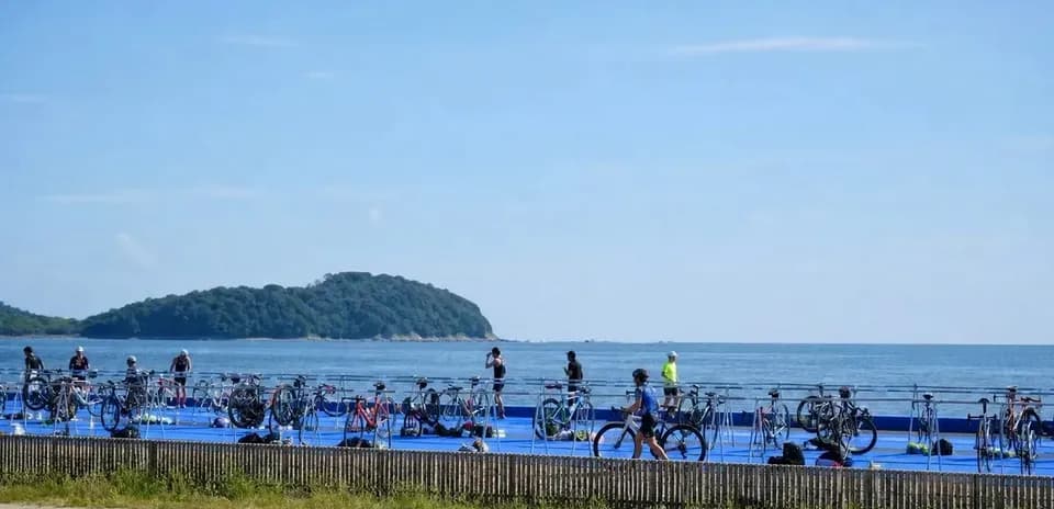 Cyclists preparing near the ocean for event