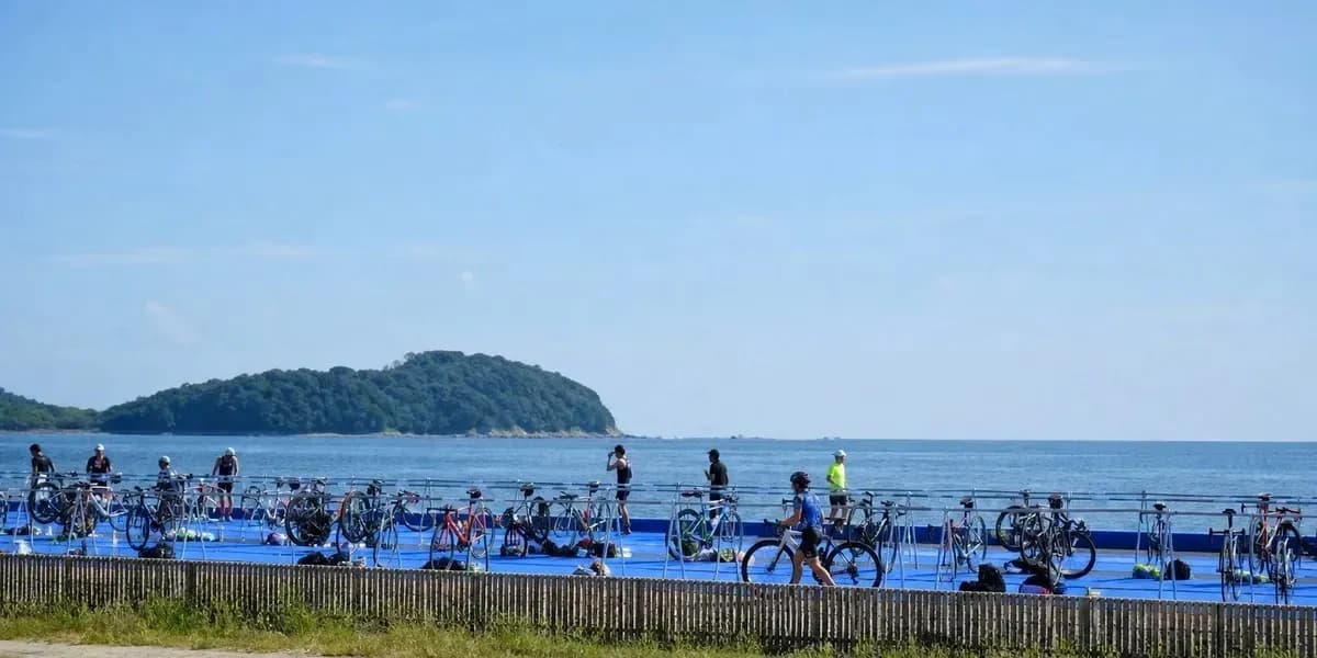 Cyclists preparing near the ocean for event