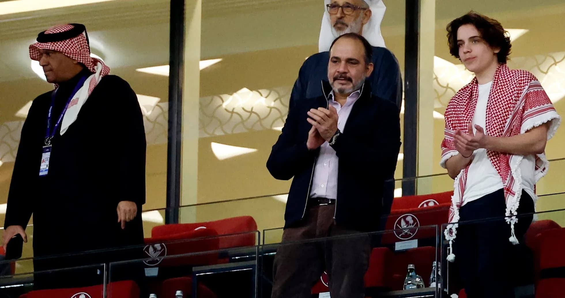 Spectators applauding in a stadium box