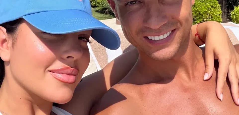 Couple posing together in sunny outdoor setting