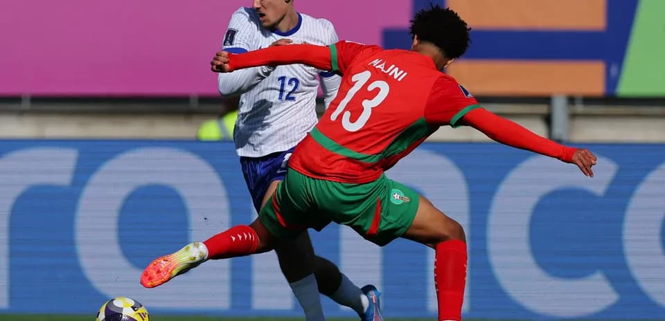 Joueur marocain dribblant un adversaire lors du match