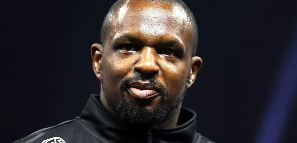 Athlete wearing a black jacket on stage