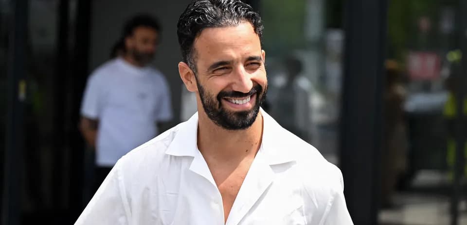 Homme souriant portant une chemise blanche à l'extérieur