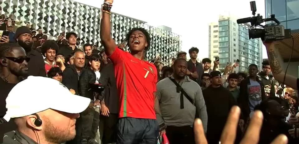 Supporter in Portugal jersey addressing a crowd