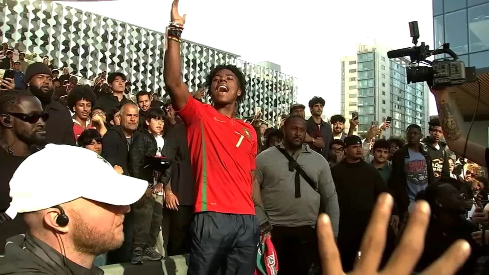 Supporter in Portugal jersey addressing a crowd