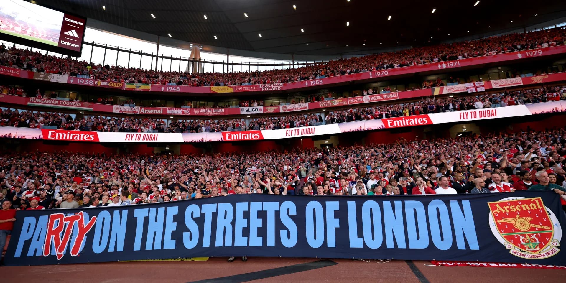 Supporters holding banner at Arsenal match