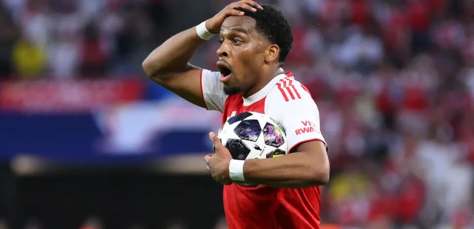Joueur d'Ajax tenant un ballon avec surprise