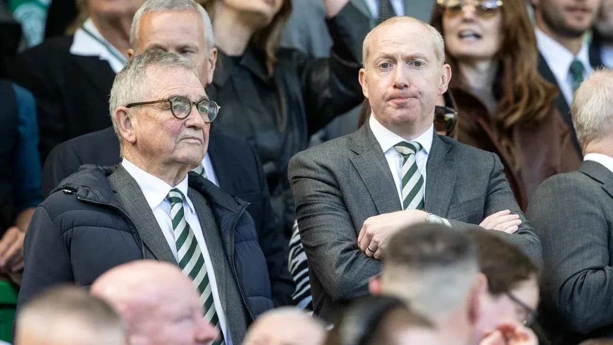 Deux hommes en costume dans les tribunes d'un match