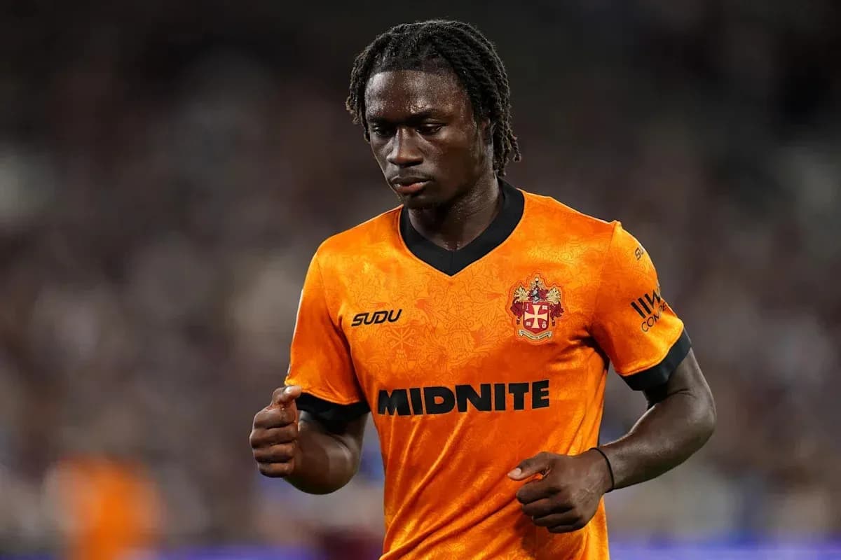 Joueur en maillot orange marchant sur le terrain