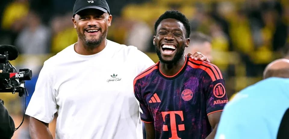 Deux hommes souriant sur le terrain de football