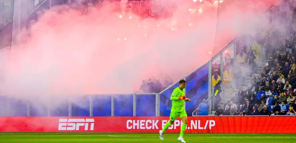 Gardien de but marchant dans une ambiance de fumigènes