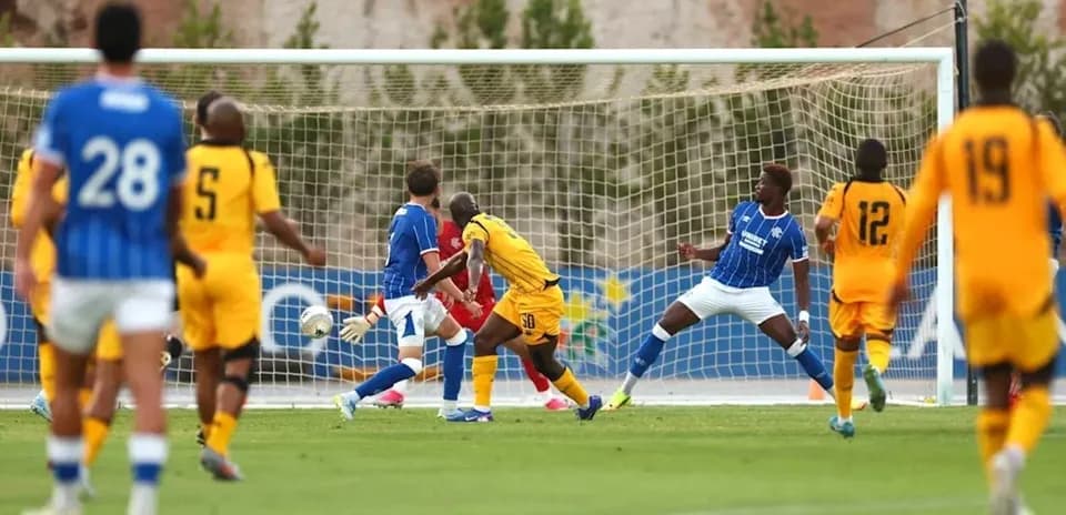 Action during football match with players near goal