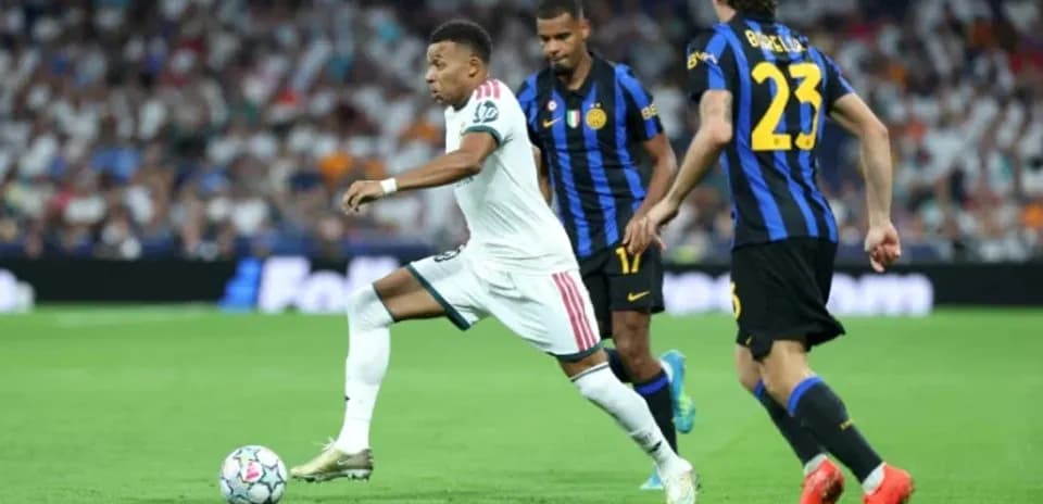 Kylian Mbappé dribbling past defenders during match