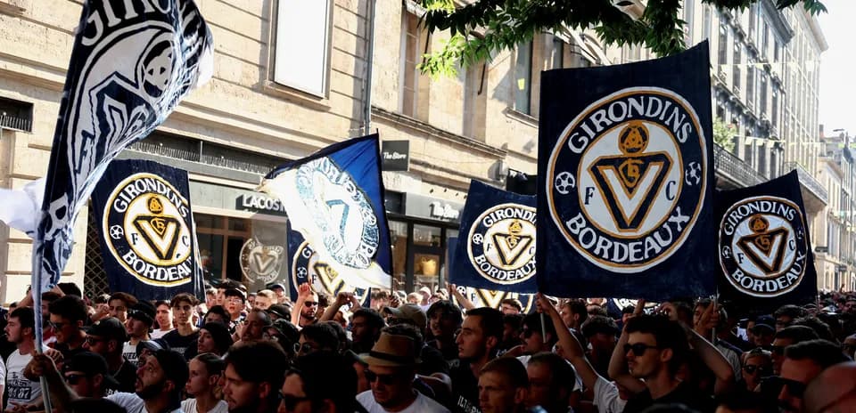 Supporters brandishing flags during Girondins de Bordeaux rally