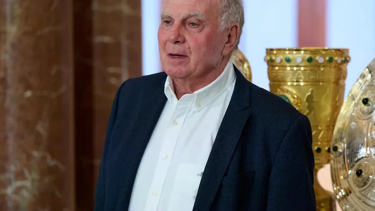 Homme parlant devant des trophées dorés