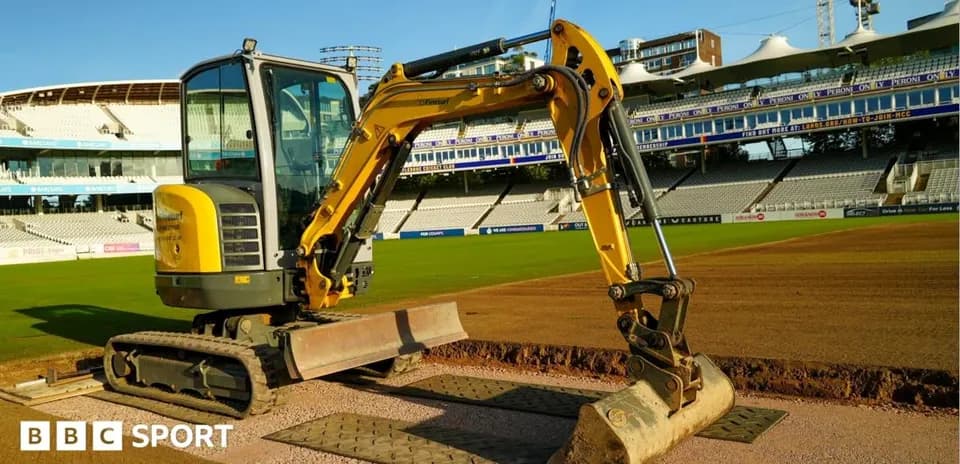 Excavator on cricket field preparing the pitch