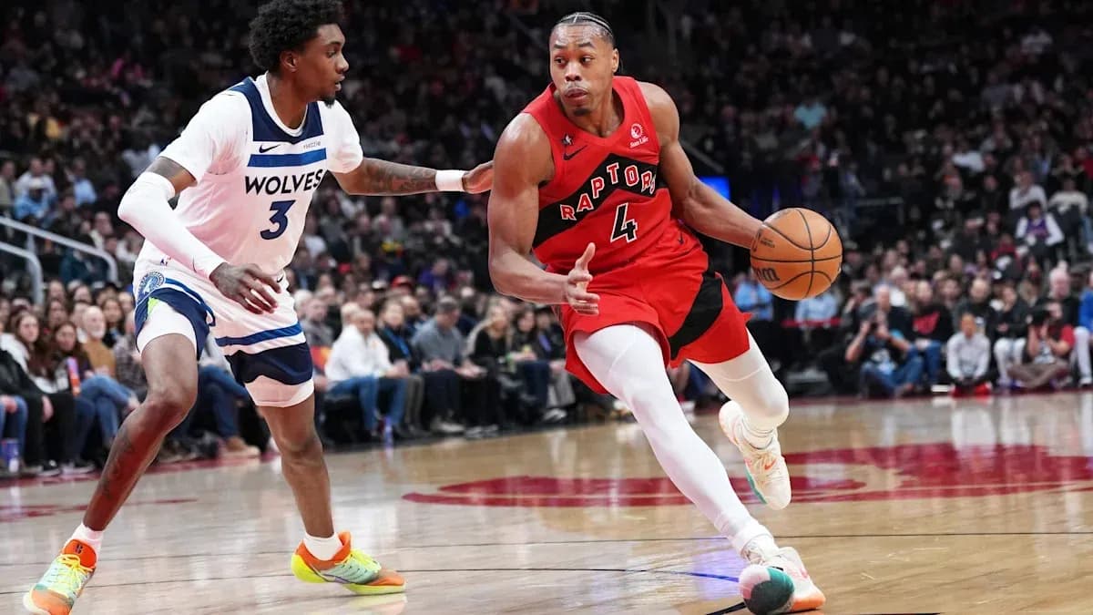 Joueur des Raptors dribblant contre un adversaire