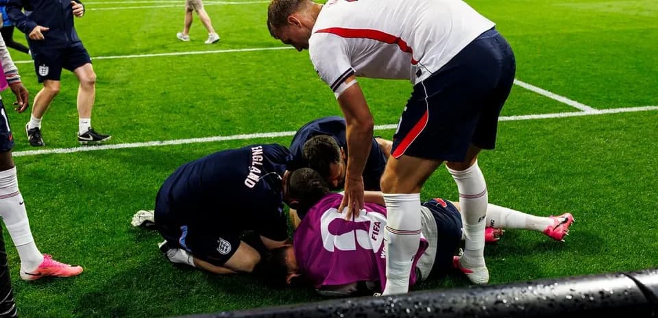 Joueurs et staff entourant un joueur au sol