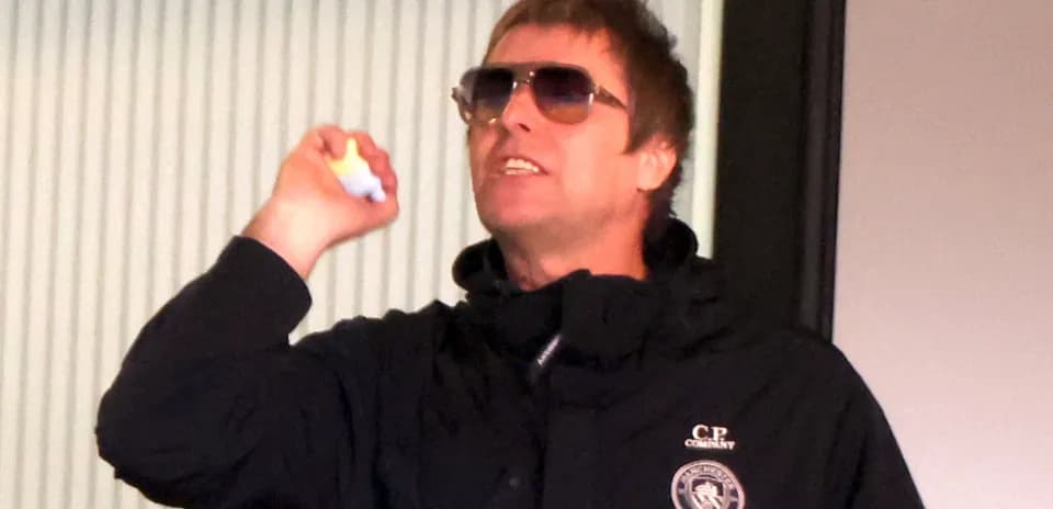 Person gesturing while wearing sunglasses indoors