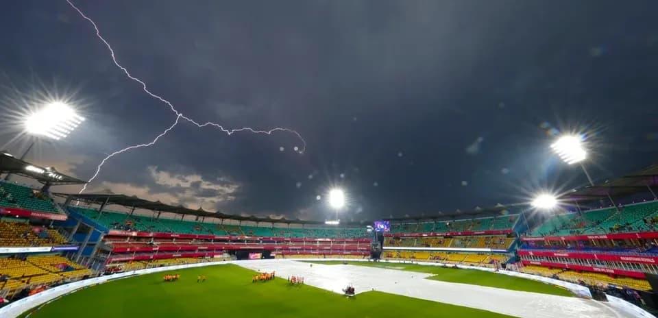 Stadium covered with tarpaulin under stormy sky