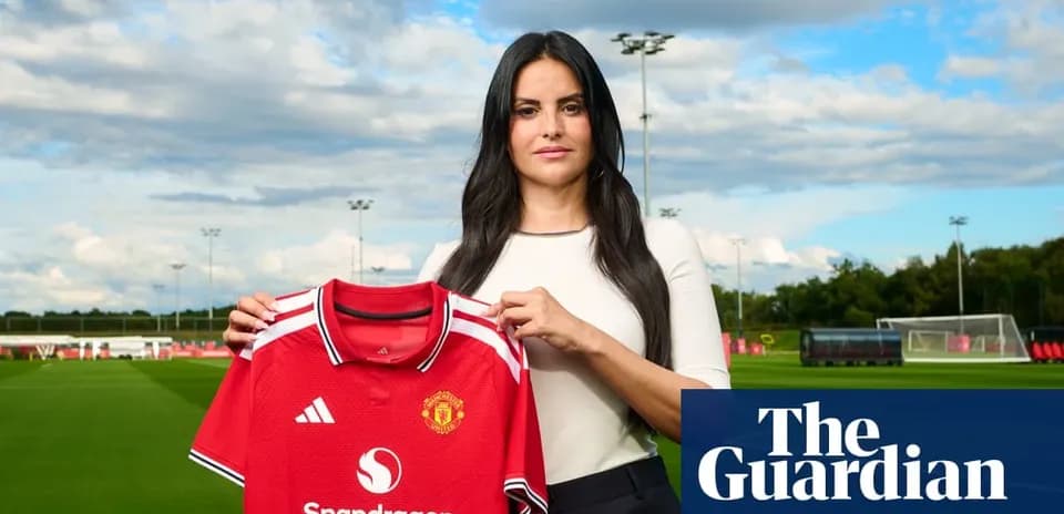 Femme tenant un maillot de Manchester United sur terrain