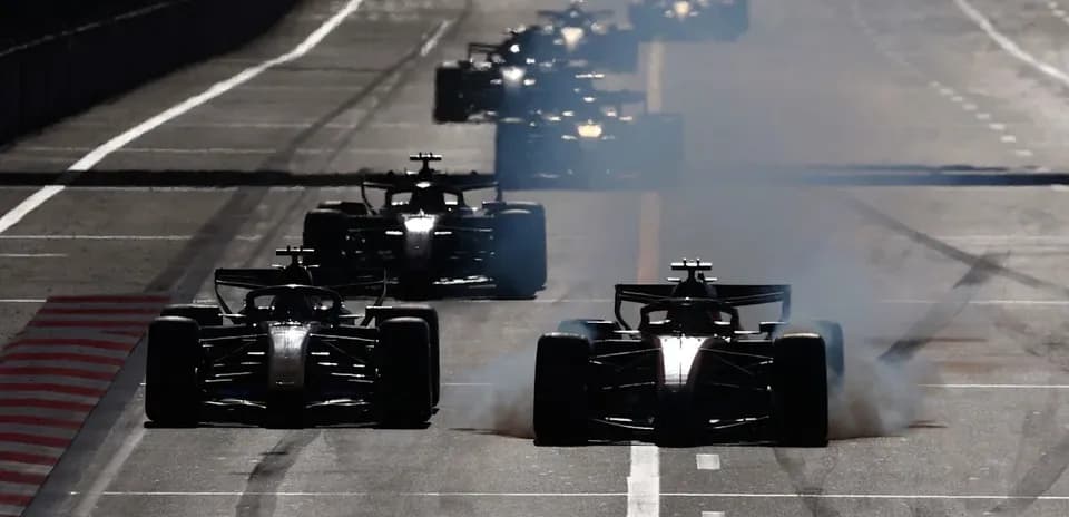 Voitures de Formule 1 sur la piste avec de la fumée
