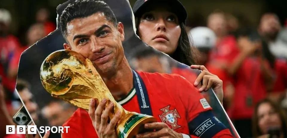 Supporter holding cutout of Cristiano Ronaldo with trophy