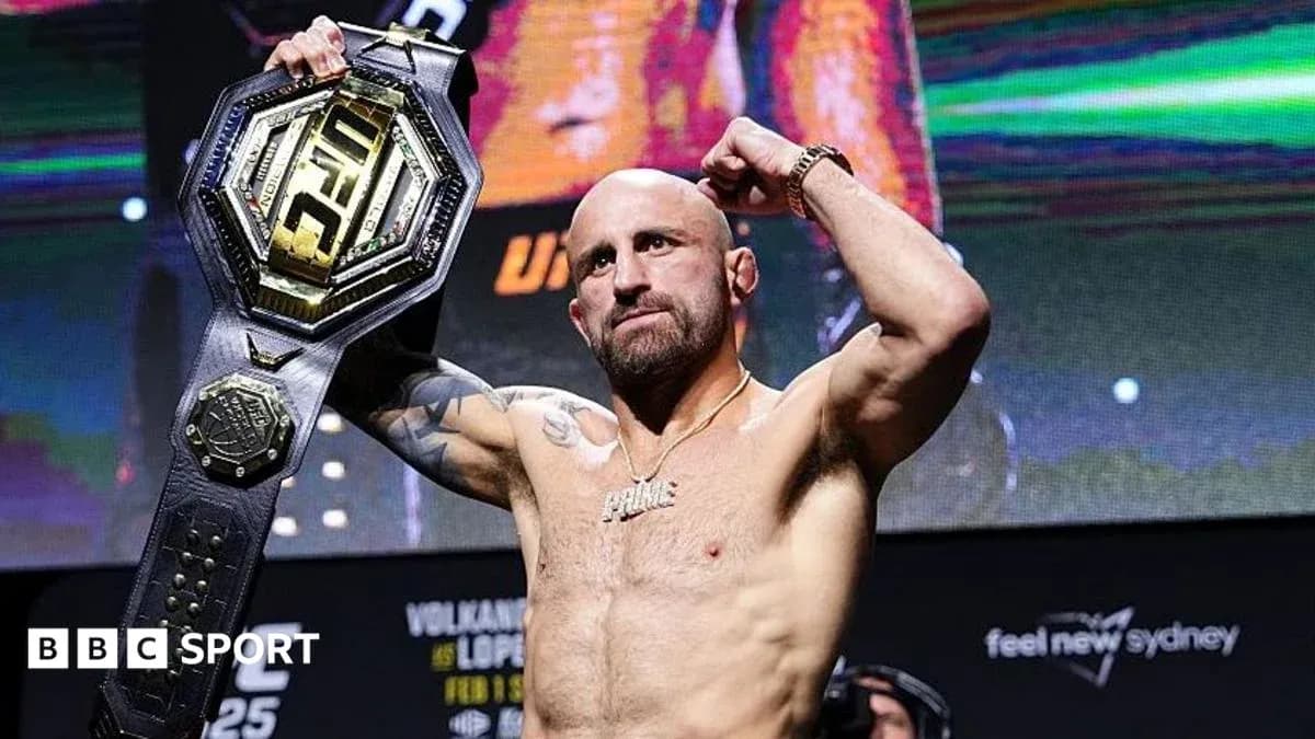 Fighter celebrating with UFC championship belt raised