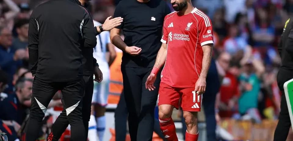 Mohamed Salah leaving the pitch with staff
