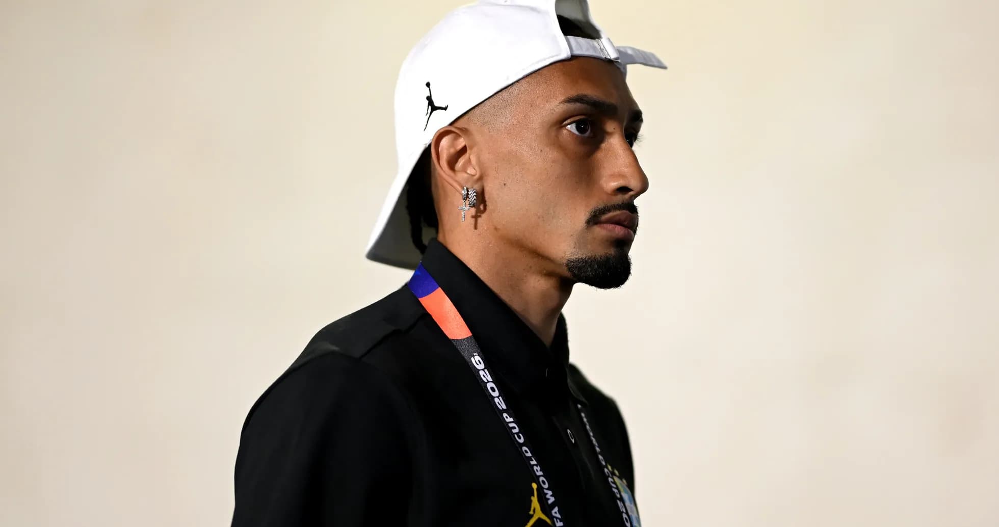 Person wearing cap and FIFA World Cup lanyard
