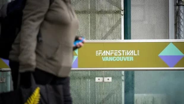 Person walking past Vancouver Fan Festival sign