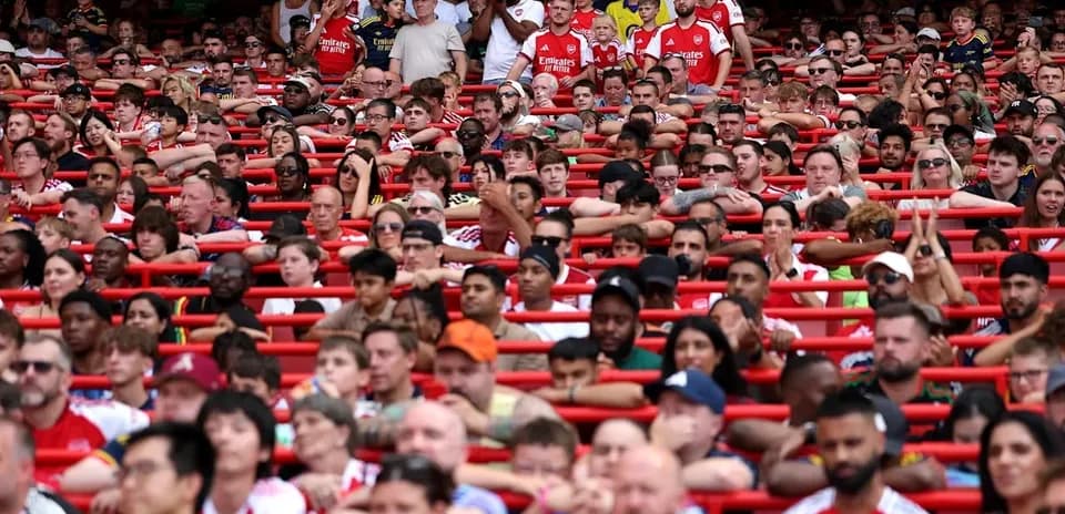 Supporters in stands wearing Arsenal jerseys
