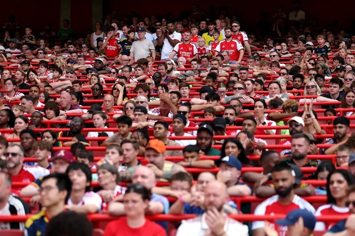 Supporters in stands wearing Arsenal jerseys